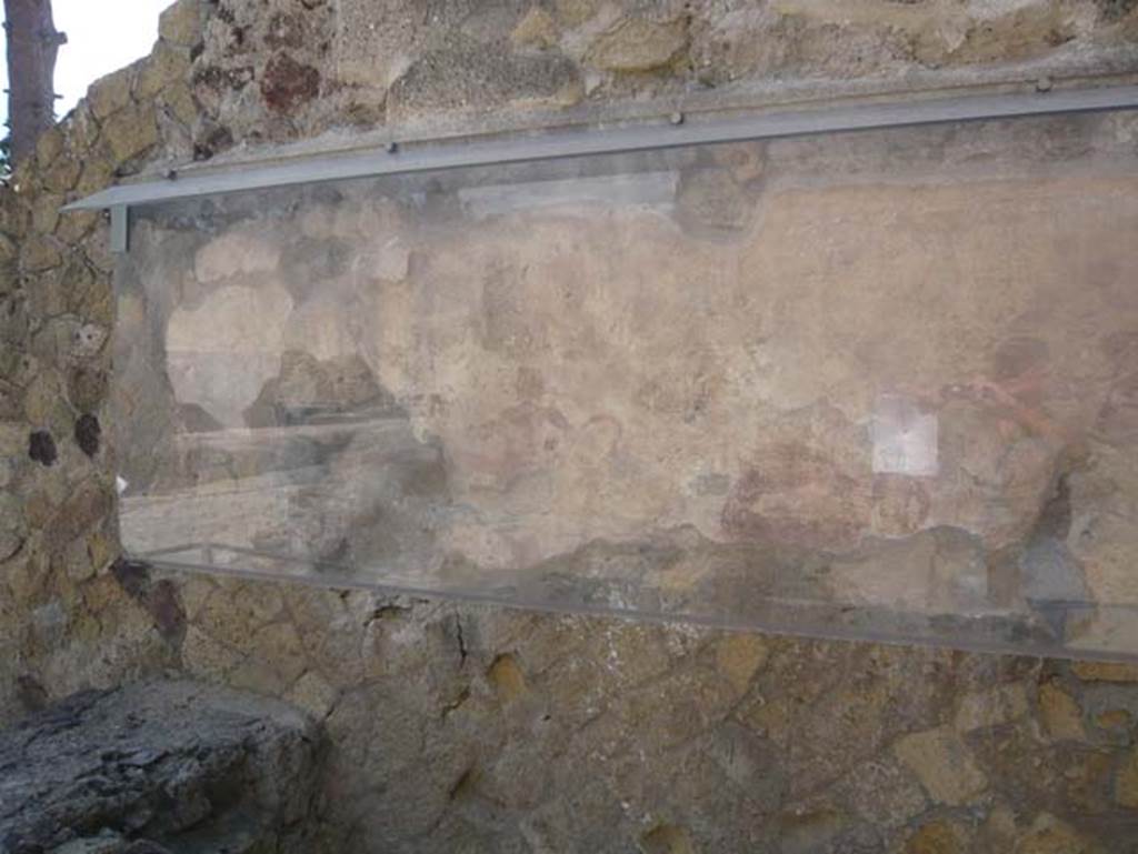 IV.17, Herculaneum, August 2013. The figure of Priapus painted on the wall behind the sales counter would have been placed there to keep the “evil eye” away. Photo courtesy of Buzz Ferebee.